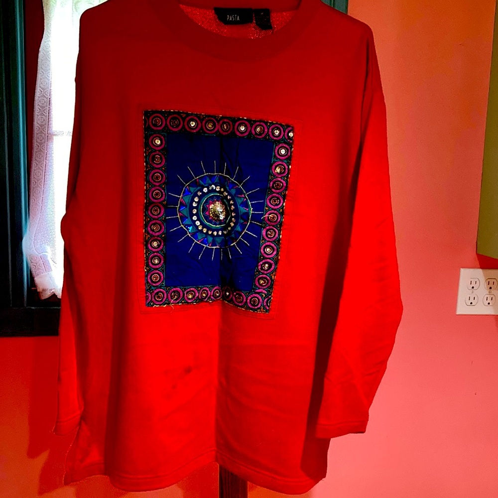 Pasta 55% Polyester 35% Cotton Red sweatshirt with Aztec motif.  Size M.